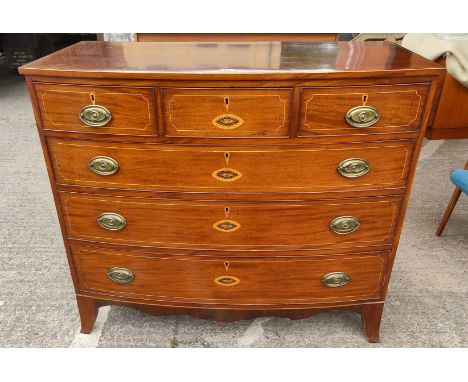 A Georgian mahogany bow fronted chest of 3 long and 3 short drawers with boxwood line and Sheraton shell inlay on bracket fee