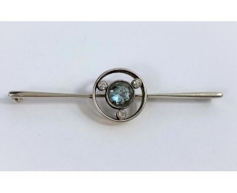 A white and yellow metal bar brooch set central light blue stone surrounded by 3 old cut diamonds, stamped 18ct', 4.8 gm 