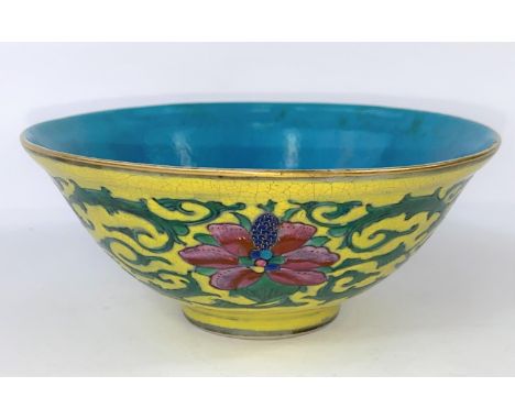 A Chinese yellow glaze bowl with detailed leaves connecting three red flowers, with turquoise glaze to the interior, seal mar