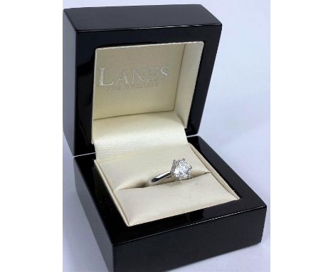 A solitaire diamond dress ring on a white metal shank, stamped 750, set with brilliant cut diamond, diameter 7.5mm, approx 1.