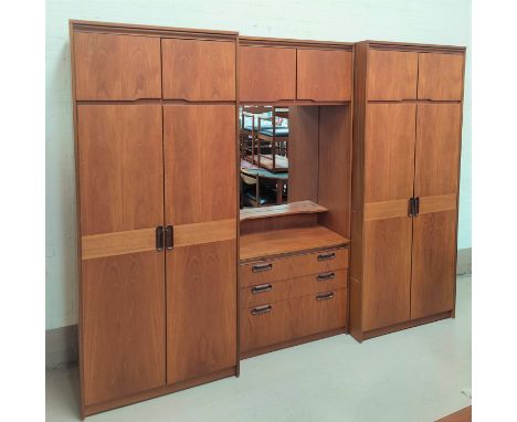 A mid century teak bedroom suite comprising of two double door wardrobes with double cupboard above H204 x D56 x L87cm (handl