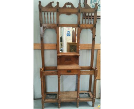 An Edwardian golden oak mirror and spindle back hall stand with glove drawer on turned legswidth 107cm x height 200cm approx