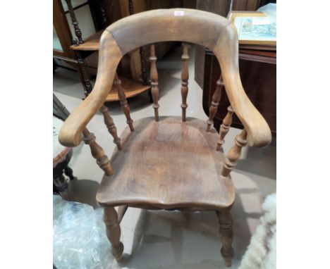 A 19th century beech and elm spindle back armchair; a rush seat ladder back armchair 