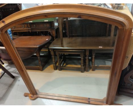 An overmantel mirror in pine arch top frame 