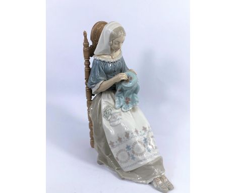 A large Lladro group: seated girl with embroidery, height 30 cm.&nbsp; In good condition with no obvious signs or damage, rep