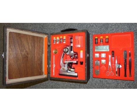 A cased microscope with slides, utensils and other various items. 