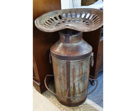 An industrial style milk churn with tractor seat. 