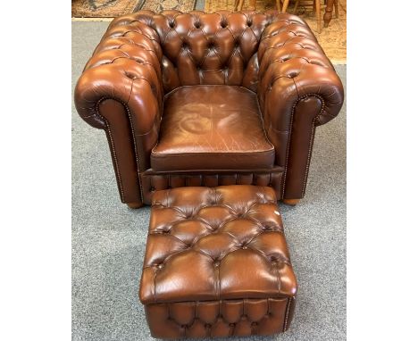 A Chesterfield style armchair in brown button back leather with similar box footstool (2). 