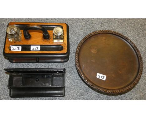 A musical wooden circular cake stand, ebonised desk tidy and a twin inkwell desk stand (3). 