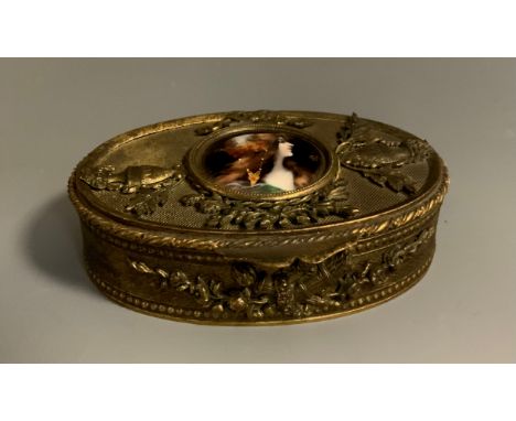 A 19th century Limoges enamelled oval ormolu and gilt metal trinket box, the hinged lid centred with a circular enamelled jew