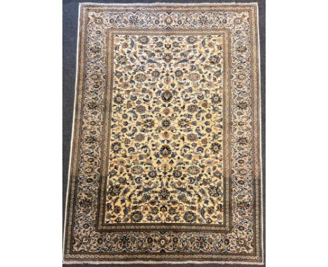 A Central Persian Kashan rug / carpet, knotted with a field of stylised flowering stems, enclosed within a similar margin, in