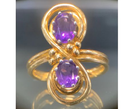 An unusual amethyst hand made dress ring, arcing crest set with two oval vibrant amethysts, ball and wire mount, 18ct gold sh