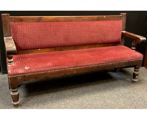 An early 20th century pine railway station Waiting-room type bench, upholstered back and seat, turned fore-legs, 99cm high x 