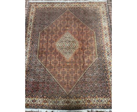 A Persian Bidjar rug / carpet, hand-knotted silk and wool mix, with central hexagonal medallion, within a geometric field of 