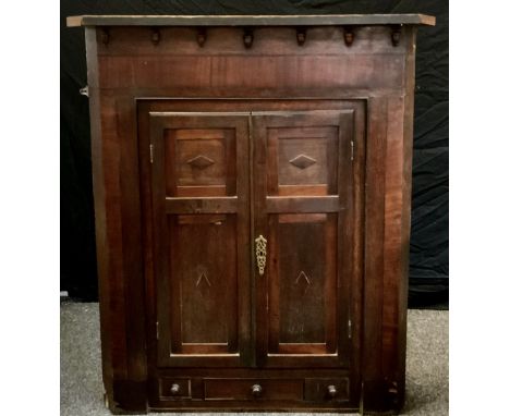 A oak corner cupboard; decorated panel doors, single drawer to frieze enclosing three interior shelves. 119cm high x 102cm wi