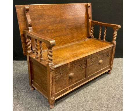 An oak monk’s bench, quarter-sawn oak lift-up top, barley-twist supports, 89.5cm high x 106.5cm wide (as a bench), 69cm high 