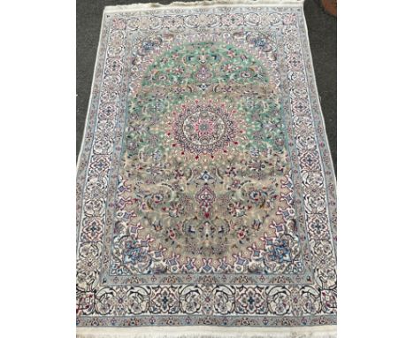 An Anatolian or Turkish woollen carpet, knotted in subdued tones of cream, blue, green, and grey, 303cm x 195cm. 