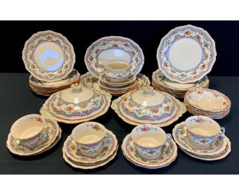 A Masons dinner service for eight, decorated with a floral border including; two graduated meat dishes, two tureens, eight di