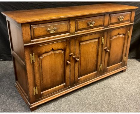 A Titchmarsh and Goodwin sideboard or dresser base, model number RL19855, having three short drawers to frieze, above three, 