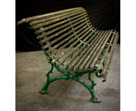 A Victorian Coalbrookdale style cast iron park bench, ‘naturalistic branches’ design cast iron supports with scrolling termin