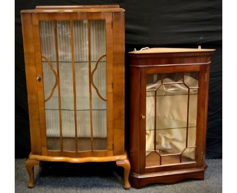 An Art Deco walnut serpentine bow front display cabinet, single door, two shelf interior, cabriole supports, 107cm high, 64cm