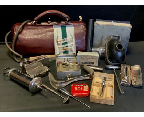 A vintage Doctors/Dentist bag with contents of assorted medical instruments and tools inc Stethoscope, Syringe and empty drug