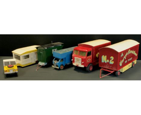 A Scratch Built Wooden model of a Fairground wagon and trailer, Fun Fair on Tour, in red, yellow and pale blue, 24cm high, 10