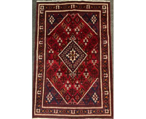 A North west Persian Josheghan rug / carpet, central diamond-shaped medallion within a field of stylised motifs, knotted in s