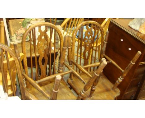 Set of five Ercol style Fleur De Lis stick back dining chairs including one carver