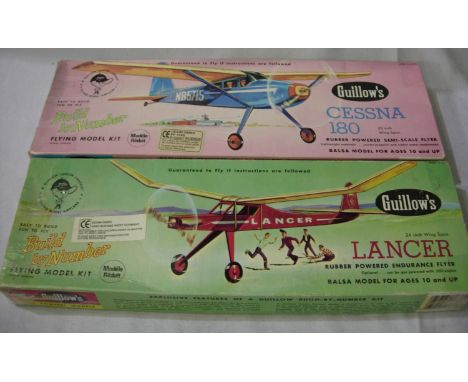 Two Guillows Balsa/Tissue rubber powered flying model aircraft kits. Cessna 180-20 inch wingspan, Lancer 24 inch wingspan. P&