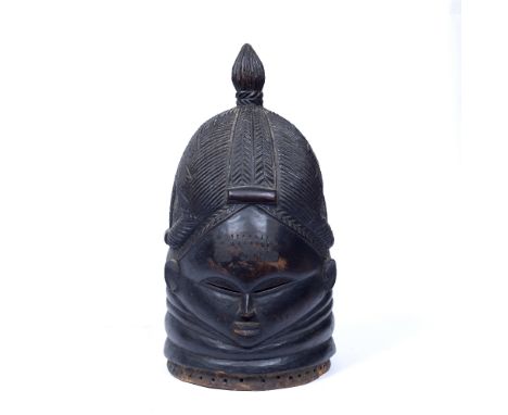 A MENDE 'BUNDU' HELMET MASK, SIERRA LEONE, carved wood with a ribbed neck, scratched carving braided and single top knot hair