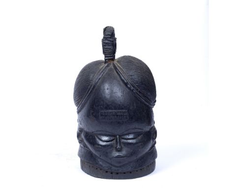 A MENDE 'BUNDU' HELMET MASK, SIERRA LEONE, carved wood with a circular top knot and lobed coiffure, ribbed neck with beaded s