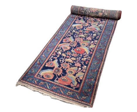 AN OLD HAMADAN BLUE GROUND RUNNER, the central pattern decorated with a design of pastel flowers within pale blue border, 486