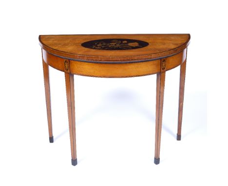 A GEORGE III SATINWOOD AND CROSSBANDED DEMI LUNE CARD TABLE the top inlaid with an oval floral spray, the square taper legs w