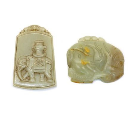 Two Chinese jade carvings, one of a pendant carved with an elephant carrying a vase, 5.8cm high. and another, carved as an el