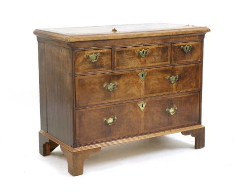 A walnut chest, with a leather inset top, three short drawers over two long drawers on bracket feet, 103cm wide, 51cm deep, 8