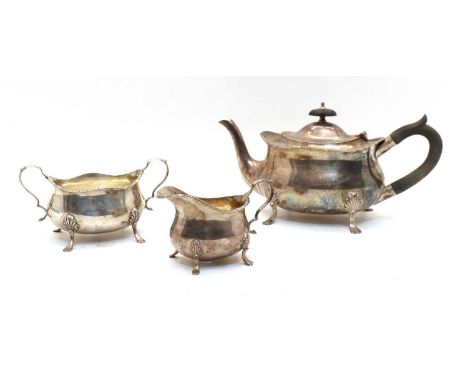 An Edwardian silver three-piece tea service, all by Messrs Hutton &amp; Sons, teapot and sugar bowl, Sheffield, 1908, the mil