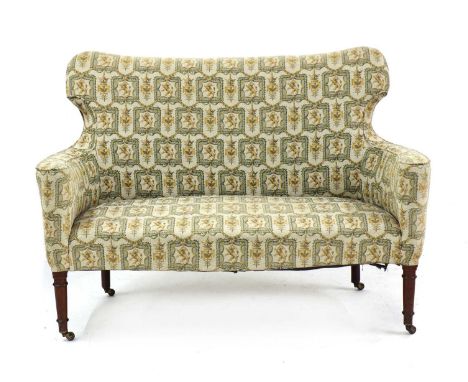 An Edwardian mahogany and upholstered settee, early 20th century, the shaped wing-back and seat with overstuffed upholstery d