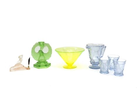 A tray with coloured glassware, comprising: blue tinted jug and six glasses, green female dancer candlestick, green fruit bow
