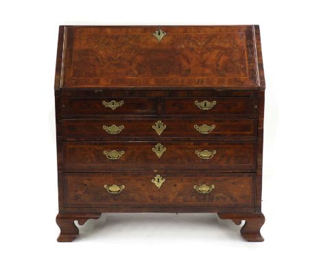 A George III walnut and feather banded bureau, the fall front enclosing a fitted interior with drawers, pigeon holes and a ce