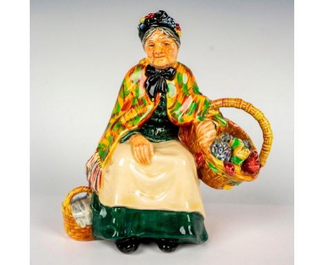 An outstanding rare, early edition character modeled as an elderly lady wearing a dark green gown, a cream apron and a patter