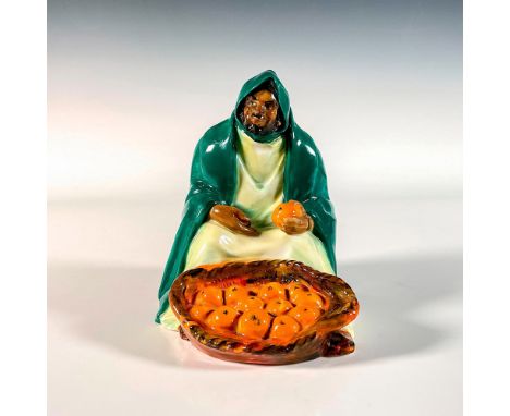 A rare and evocative glaze figure depicting a fruit selling merchant wearing a green cloak. From an early edition of the Stre