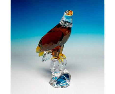 A majestic limited edition figure of an eagle perched on a rock. Stunningly created with amber crystal and light topaz. The e