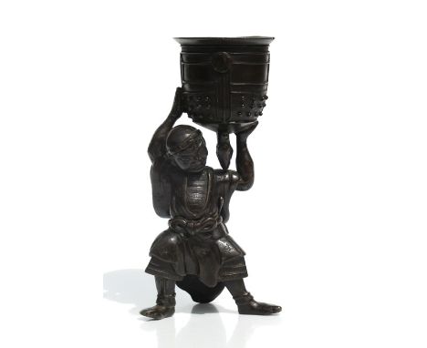 A Japanese bronze figure in the form of Benkei carrying the temple bell, 23cms high.