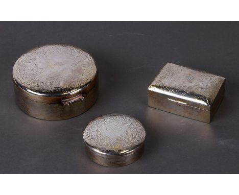 A sterling silver trinket box and cover with engraved decoration, 8cms diameter; together with two similar boxes, weight 216g