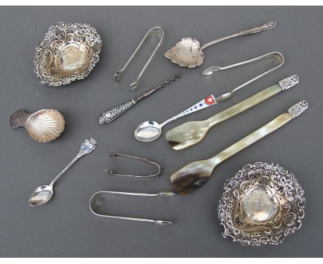 A silver caddy spoons; together with three silver spoons; pierced silver bonbon dishes; silver sugar tongs and other items.