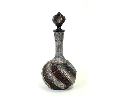 A black glass with white metal overlay and turquoise coloured cabochon decanter, made for the Turkish market, 33cms high.