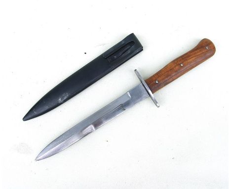 A WW2 fighting knife with wooden studded grip handle in its steel scabbard. Blade length 17.5cms (6.875ins)