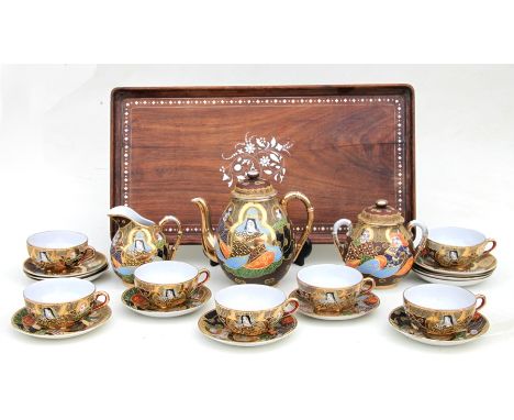 A Japanese Satsuma six-person tea set; together with an Anglo- Indian rosewood galleried tray with inlaid bone decoration.