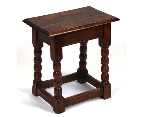 A 17th century style oak joint stool with bobbin turned legs, 44cms wide.